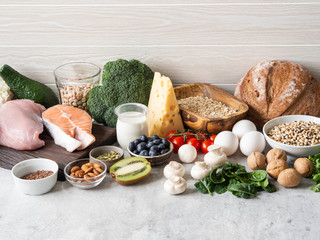 Healthy raw clean ingredients - fruits, vegetables, dairy products, eggs, legumes, dietary meat and fish, nuts and seeds on the table. Copy space. Balanced healthy food concept