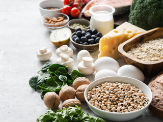 Healthy raw clean ingredients - fruits, vegetables, dairy products, eggs, legumes, dietary meat and fish, nuts and seeds on the table.