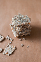 Obraz na płótnie Canvas Crunchy crispbread on a brown background, cereal flax seed ,sunflower seeds protein bread bar