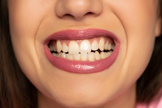 Young woman showing her teeth