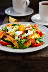 Detox healthy dinner from Quinoa Salad with vegetables such as cucumbers, cherry tomatoes, pepper and goat cheese. Vegetarian food.