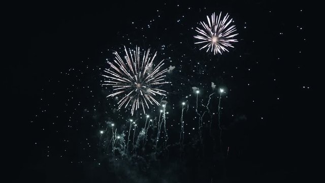 Beautiful fireworks in the night sky. Pyrotechnic performance fireworks, firecrackers, fires and explosions.Festival Celebration Event Carnival Parade.Romantic date.Golden shining with bokeh 4K.