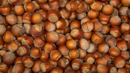 Hazelnut on store shelves and the buyer's hand with a shovel
