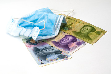 the concept coronovirus and economy of china chinese yuan money lie near medical hygiene mask