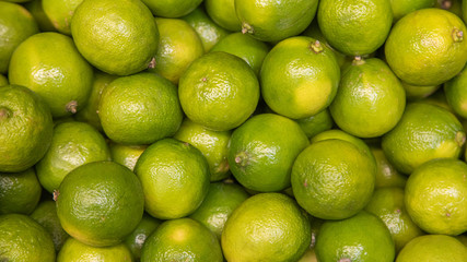 Colorful Display Of Lemons in a basket at bio market or grocery store. Organic Fresh lemons background close up