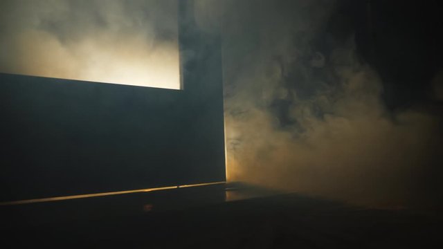Smoke of fire coming from the cracks under the door in the room