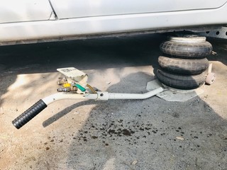 Pneumatic car air jack in the car repair service shop