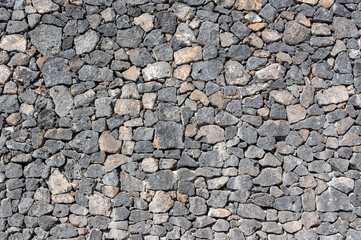 Texture of stone wall made of volcanic rocks