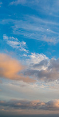 Fantastic clouds at sunrise, vertical panorama