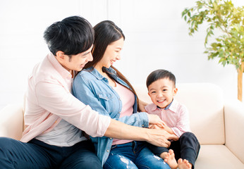 happy Family playing and  sitting on the sofa in the living room