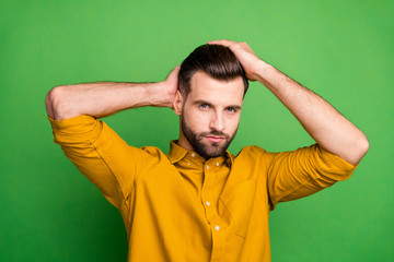 Close-up portrait of his he nice attractive content virile bearded guy touching hair modern coiffure isolated over bright vivid shine vibrant green color background