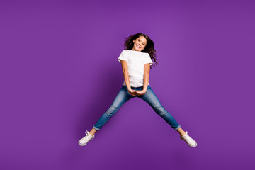 Fototapeta na wymiar Full length body size view of her she nice attractive lovely cheerful cheery girlish wavy-haired girl jumping having fun isolated on bright vivid shine vibrant purple violet lilac color background