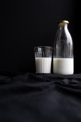 Glass and bottle of milk copyspace