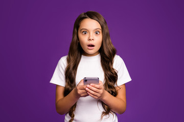 Close-up portrait of her she nice attractive lovely cute wondered astonished wavy-haired girl using cell 5g app reading news isolated on bright vivid shine vibrant purple violet lilac color background