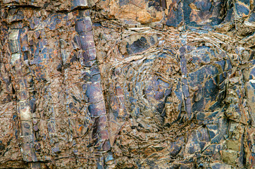 Color rock close up. Natural forms in stone structure. Background, texture..