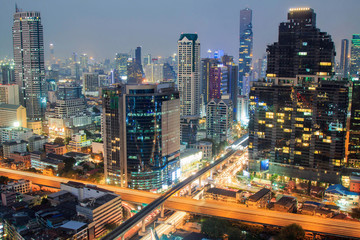 Fototapeta na wymiar Aerial view of Bangkok buildings urban city downtown at night with car light on the street.