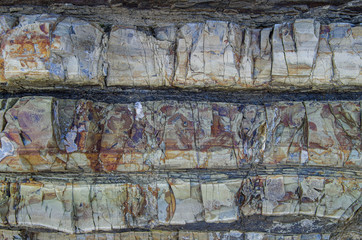 Color rock close up. Natural forms in stone structure. Background, texture.