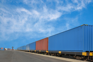 Fototapeta na wymiar Cargo train platform with freight train Containers on the train on crane loading in port background.
