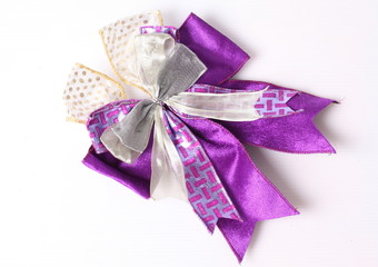 Violet bow made of ribbon isolated on white