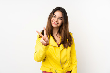 Young caucasian woman isolated on white background smiling and showing victory sign