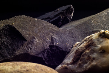 Stones macro close up, black background. Textured wallpaper