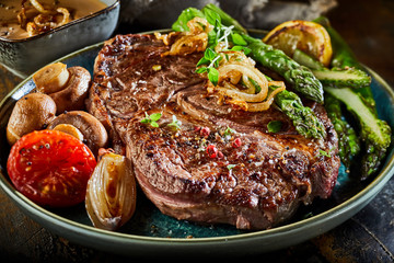 Large portion of grilled beef steak with asparagus - obrazy, fototapety, plakaty