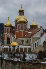 Modern brick Church of the Nativity of St. John the Baptist in the Carpathian village of Yaremche in winter. Ukraine