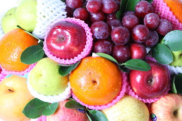 Naklejka na ściany i meble Different fruits in wicker basket 