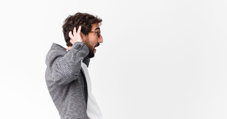 young crazy bearded businessman against copy space wall