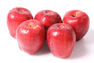 Red apple with water drops isolated on white background.
