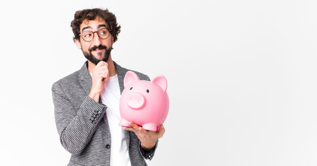 young crazy bearded businessman with a piggy bank