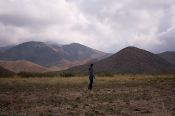men in the field, view Los andes mountain
