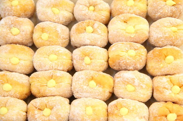 Ready-made donuts covered with powdered sugar on a tray