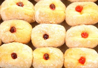 Ready-made donuts covered with powdered sugar on a tray