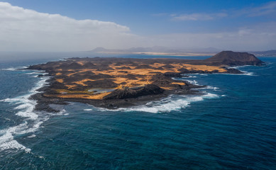 Stunning high angle panoramic aerial drone view of Isla de Lobos, a small uninhabited island just 2 kilometres off the coast of Fuerteventura, Canary Islands, Spain. October 2019