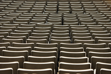 A row of empty green seats in a football stadium