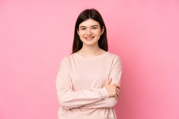 Young Ukrainian teenager girl over isolated pink background keeping the arms crossed in frontal...