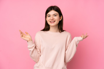 Young Ukrainian teenager girl over isolated pink background smiling a lot