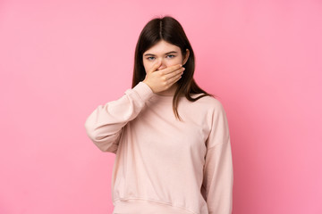 Young Ukrainian teenager girl over isolated pink background covering mouth with hands