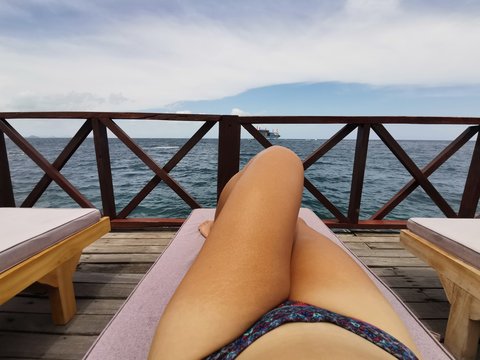 Sexy lady relaxing on the lazy chair tanning in Mabul Island, Semporna. Tawau. Sabah, Malaysia. Borneo. The Land Below The Wind.