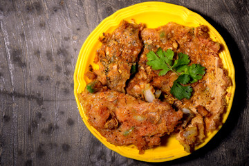omelet is decorated in yellow plate with green coriander leaves