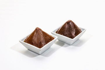 Miso, traditional Japanese seasoning. Two types, dark and light brown paste, isolated on white background