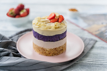  cake with cream and strawberries. Raw dessert with berries. Strawberries and almonds. Layer cake.