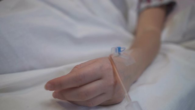 In the hospital. Close-up of a woman's hand with a catheter