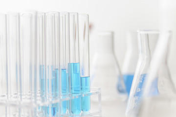 Test tubes and flasks with blue liquid in a laboratoy.