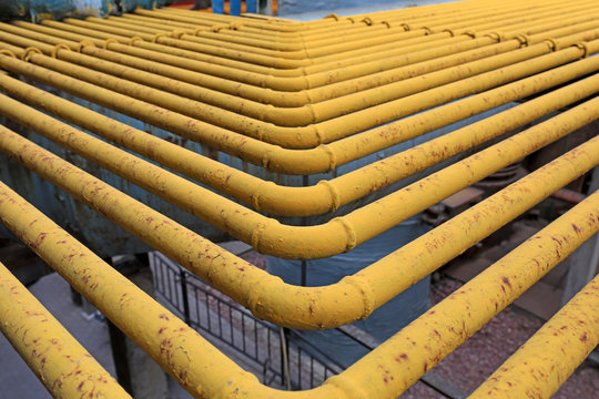 Oxidized yellow steel pipe in a factory