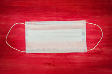 white medical mask on a red background