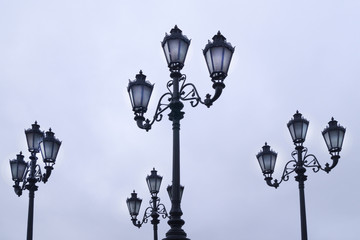 black wrought iron lanterns in the park against the sky