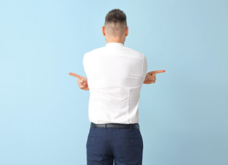 Businessman pointing in different directions on color background. Concept of choice