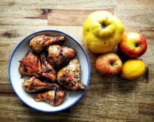 Backed chicken legs on wooden table